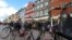 Denmark -- Danish and foreign tourists enjoy a walk near Copenhagen Nyhavn's ancient harbour 24 July 2002.
