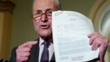 Washington U.S. - Democratic Senate leader Chuck Schumer / Democratic Senate leader Chuck Schumer holds up a copy of the telephone conversation between U.S. President Donald Trump and Ukraine President Volodymyr Zelenskiy while speaking to reporters in th