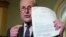 Washington U.S. - Democratic Senate leader Chuck Schumer / Democratic Senate leader Chuck Schumer holds up a copy of the telephone conversation between U.S. President Donald Trump and Ukraine President Volodymyr Zelenskiy while speaking to reporters in th