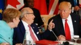 Tunisia's President Beji Caid Essebsi (C) gestures to U.S. President Donald Trump as German Chancellor Angela Merkel (L) looks on at the G7 Summit expanded session in Taormina, Sicily, Italy May 27, 2017.