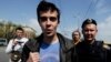 Russia -- Opposition activist Roman Dobrokhotov (C) is detained by the police outside the Cathedral of Christ the Savior in Moscow, 29Apr2012