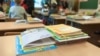 RUSSIA--ST. PETERSBURG/School exercise and ABC books are on the desk in classroom. Parents with kids are indoor. Children go back to school at first time in September/SEPTEMBER, 2014 Shutterstock