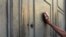 Greece -- A pensioner leans against the main door of a branch of the National Bank in Athens, July 7, 2015