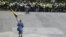Venezuela -- A nun holding a Venezuelan flag walks towards a line of riot police during a protest against the government of President Nicolas Maduro in Caracas on June 7, 2017