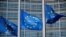 FILE PHOTO: European Union flags fly outside the European Commission headquarters in Brussels
