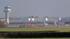 I.K. -- A police vehicle stands on the closed runway at Gatwick Airport after drones flying illegally over the airfield forced the closure of the airport, in Gatwick, December 20, 2018