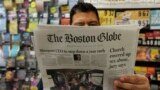 U.S. -- Phillip Minias, 46, owner of Snax Express, reads the Boston Globe, in Boston, Massachusetts, August 15, 2018