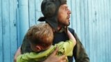 RUSSIA -- Soldier holds a child that was a hostage of Chechen terrorists in Budyonovsk on June 17, 1995