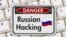 Generic – Warning sign with text Russian hacking on a keyboard. Russia hacking concept