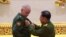 BURMA -- Russian Deputy Defense Minister Alekaandr Fomin (L) receives a medal from Myanmar armed forces chief Senior General Min Aung Hlaing in Naypyidaw, March 26, 2021