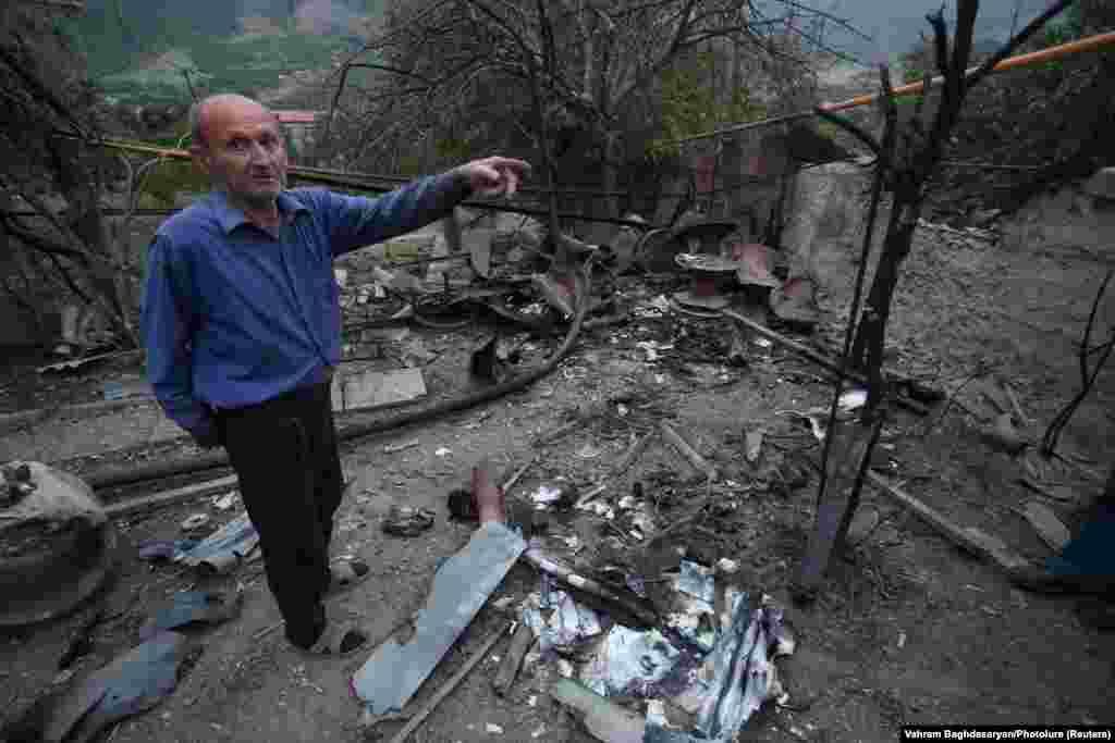 A man stands amidst the rubble of his house in the town of Hadrut in the disputed region of Nagorno-Karabakh. His house was destroyed from shelling by Azerbaijani forces, he said.
