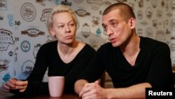 Russian artist Pyotr Pavlensky (right) speaks while his partner Oksana Shalygina looks on during an interview with Reuters in Kyiv on January 4.