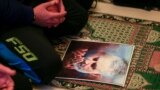 LEBANON -- A man prays next to a picture of late Iranian Major-General Qassem Soleimani, head of the elite Quds Force, inside a mosque in Ghazieh, January 3, 2020