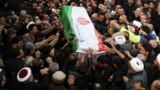 IRAN -- A handout picture provided by the office of Iran's Supreme Leader Ayatollah Ali Khamenei shows mourners carrying the casket of slain top Iranian military commander Qasem Soleimani, after he was killed in a US strike in Baghdad last week, in the ca