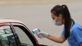 Kosovo - A nurse checking body temperature of people crossing the border between Kosovo and Albania - COVID-19