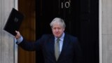 U.K. -- Britain's Prime Minister Boris Johnson waves as he returns to 10 Downing Street in central London on December 13, 2019, after delivering a speech following his Conservative party's general election victory.