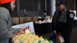 New York, U.S. - employee receives a donation at a food distribution center / A Transportation Security Administration (TSA) employee receives a donation at a food distribution center for federal workers impacted by the government shutdown, at the Barclay