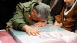 IRAN -- A handout picture provided by the office of Iran's Supreme Leader Ayatollah Ali Khamenei shows an unidentified Revolutianary Guard commander paying over the caskets of slain Iranian military commander Qasem Soleimani during a funeral ceremony at T