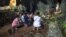 THAILAND -- Family members pray before a shrine in Tham Luang cave area as operations continue for the 12 boys and their coach trapped at the cave at Khun Nam Nang Non Forest Park in the Mae Sai district of Chiang Rai province on July 5, 2018.