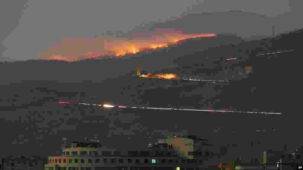 A forest burns in the mountains outside Karabakh's main town of Stepanakert (Khankendi) on October 31, 2020, after what Armenia alleged was an Azerbaijani attack with white phosphorus munitions. Azerbaijan rejected the charge as "false and fake," Turkey's official Anadolu Agency reported. On November 20, 2020, the Azerbaijan National Agency for Mine Action detonated what it claimed were Armenian white phosphorus munitions in the formerly Armenian-occupied districts of Fuzuli and Jabrayli, outside of Karabakh.&nbsp;