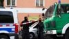 GERMANY -- Armed police officers stand behind a cordon during a raid at the Al-Irschad association in Berlin, Germany, 30 April 2020. 