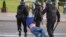 BELARUS -- Belarusian law enforcement members detain a man during an opposition protest following the inauguration  of Belarusian President Lukashenka in Minsk, September 23, 2020