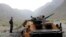 KYRGYZSTAN -- A Kyrgyz official examines a burned-out APC at the Golovnoy water intake on the Kyrgyz-Tajik border in the village of Kok-Tash, 1,200 km from Bishkek, Kyrgyzstan, 05 May 2021. Fighting broke out at the Tajik-Kyrgyz border on 28 April over th