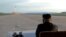 North Korean leader Kim Jong Un watches the launch of a Hwasong-12 missile