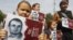UKRAINE – Ukrainians hold posters with the hashtag '#Save Oleg Sentsov' during a rally on the 100th day Ukrainian film director Oleg Sentsov's hunger strike with protesters demanding his release, in front of the Russian embassy in Kyiv, 21 August 2018