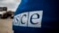  Ukraine -- OSCE representative near checkpoint in Stanitsya Luhanska, logo, Luhansk region, 18Mar2016