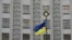 UKRAINE – A Ukrainian national flag flies in front of the government building in central Kyiv, March 3, 2016