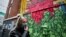 RUSSIA -- A woman wearing a protective mask walks in front of a graffiti showing a coronavirus related scene on a wall in Moscow, January 26, 2021