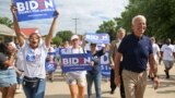 Iowa, U.S. - Democratic 2020 U.S. presidential candidate and former Vice President Joe Biden / Democratic 2020 U.S. presidential candidate and former Vice President Joe Biden walks with supporters at the Independence Day parade in Independence, Iowa, U.S