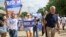Iowa, U.S. - Democratic 2020 U.S. presidential candidate and former Vice President Joe Biden  / Democratic 2020 U.S. presidential candidate and former Vice President Joe Biden walks with supporters at the Independence Day parade in Independence, Iowa, U.S
