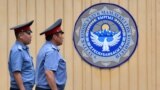 KYRGYZSTAN -- Kyrgyz law enforcement officers patrol in front of the entrance to the State Committee for National Security (GKNB) headquarters, where a case hearing for former president Almazbek Atambaev is held, in Bishkek, August 16, 2019