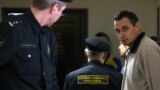 RUSSIA -- Ukrainian film director Oleh Sentsov (R), detained in Crimea, is escorted to a court hearing in Moscow, December 26, 2014