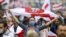 BELARUS -- A demonstrator wearing a face mask to protect against coronavirus waves an old Belarusian national flag during an opposition rally to protest the official presidential election results in Minsk, Belarus, Sept. 27, 2020