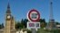 Belgium - A model of a customs road sign is seen at the mock border of the United Kingdom, with a model of Big Ben (L), and the European Union, with a model of the Eiffel Tower, during the reopening of the 'Mini-Europe' theme park of small-scale models of