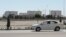 Turkmenistan. White car on the road. White houses. Mosque. Ashgabat. June 2020