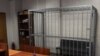 Russia -- An employee stands near the empty defendant's cage in the Tverskoy district court in Moscow, 11Mar2013