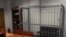Russia -- An employee stands near the empty defendant's cage in the Tverskoy district court in Moscow, 11Mar2013