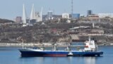 Vladivostok, Russia - A vessel sails with backdrop of the Russian far-eastern city of Vladivostok