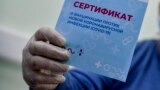 RUSSIA -- A man shows a certificate of getting a shot of Russia's Sputnik V coronavirus vaccine in Moscow, December 28, 2020