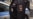 RUSSIA -- A woman wearing a protective gear follows a policeman detaining her for throwing a stone and damaging a municipal vehicle disinfecting a street in downtown Moscow, October 22, 2020