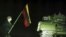 LITHUANIA -- A man holding Lithuanian flag stands near a Soviet tank in Vilnius, January 13, 1991