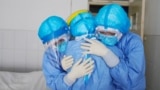 medical staff members hugging each other in an isolation ward at a hospital in Zouping in China's easter Shandong province