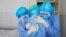 medical staff members hugging each other in an isolation ward at a hospital in Zouping in China's easter Shandong province
