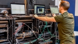 A man works next to servers specialised in cyber security 