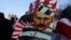 Minsk, Belarus - A demonstrator carries a placard depicting Belarusian President Alexander Lukashenko during an opposition rally to reject the presidential election results