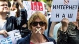 Russia -- A protester with tape covering her mouth takes part in the March for Free Internet in central Moscow, July 23, 2017